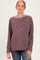 woman wearing a maroon and cream striped maternity top with long sleeves and a relaxed fit