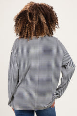 woman wearing a black and white striped maternity top, showing the back view with loose fit and wide sleeves