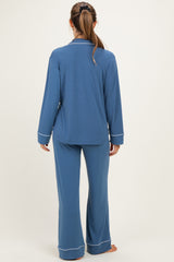 woman wearing a blue maternity pajama set with long sleeves and wide-leg pants, showing a relaxed fit