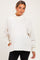 woman wearing an oversized cream maternity sweatshirt with a mock neck and long sleeves, paired with black leggings