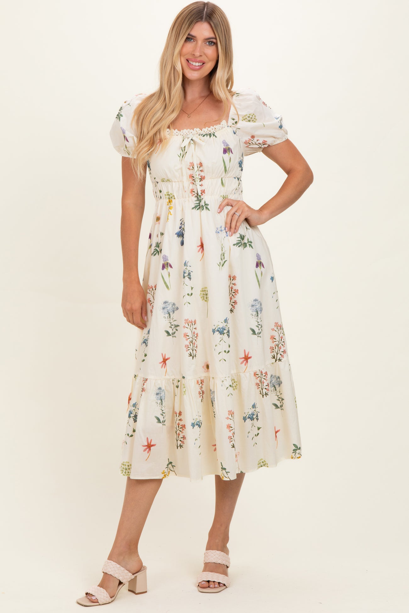 woman wearing a floral print midi dress with puff sleeves and a smocked bodice