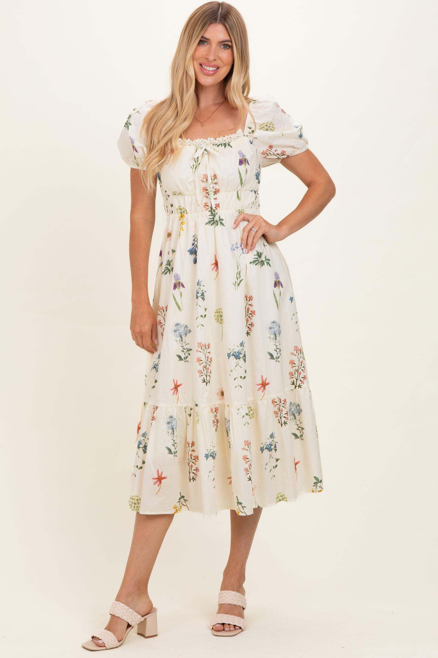 woman wearing a floral print midi dress with puff sleeves and a smocked bodice