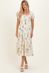 woman wearing a cream floral print midi dress with puff sleeves and smocked bodice