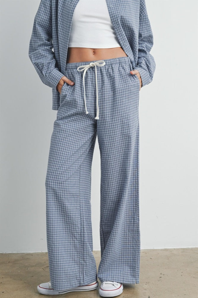 woman wearing blue and white checked wide-leg pants with drawstring waist and pockets
