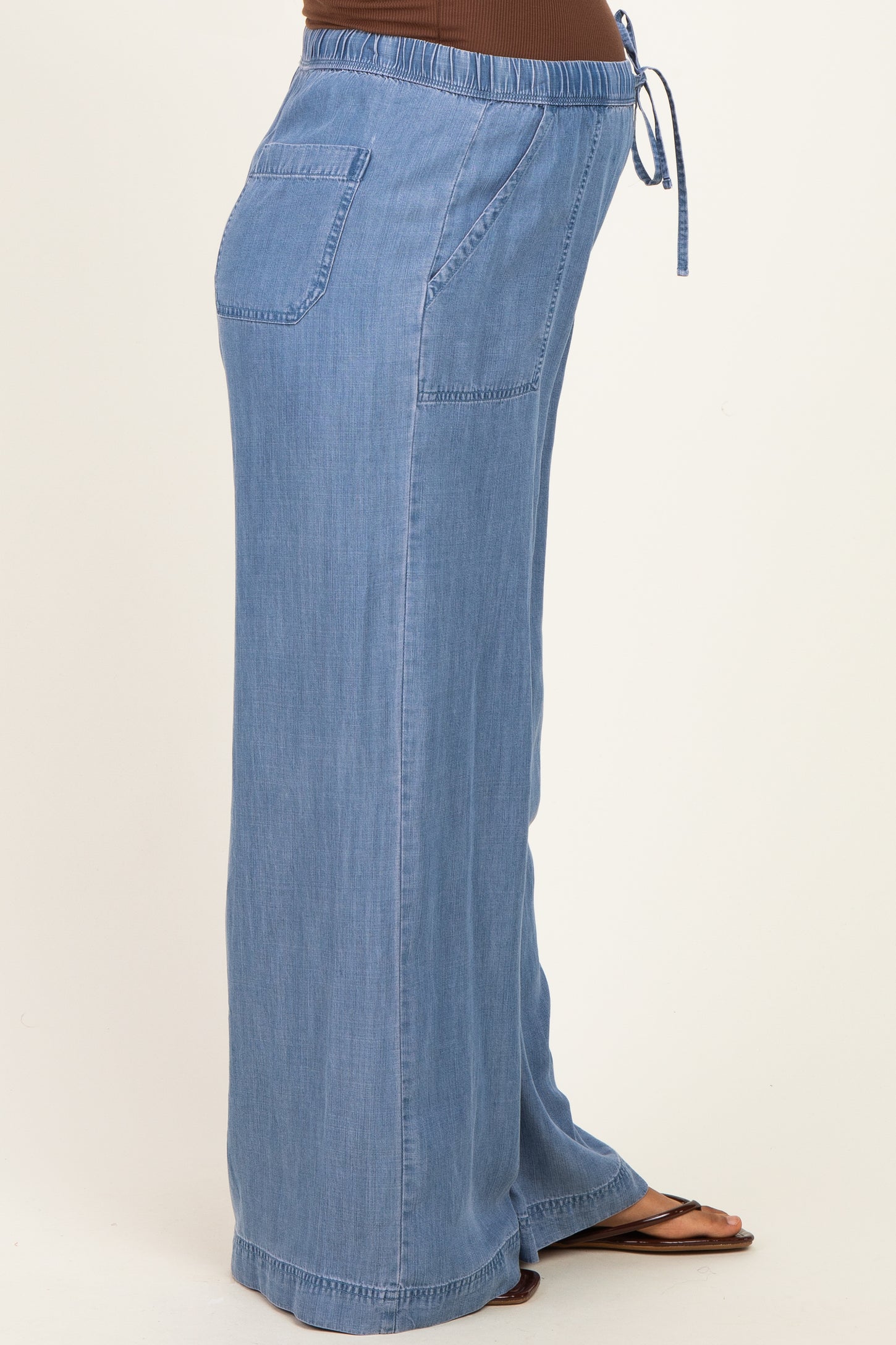 woman wearing light blue maternity wide-leg pants with a drawstring waist and side pockets