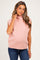 woman wearing a light pink sleeveless maternity sweater with a mock neck and baby bump visible