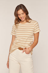 woman wearing a beige and cream striped t-shirt tucked into light-colored high-waisted pants