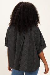 woman wearing a loose-fitting checked shirt in dark tones, shown from the back
