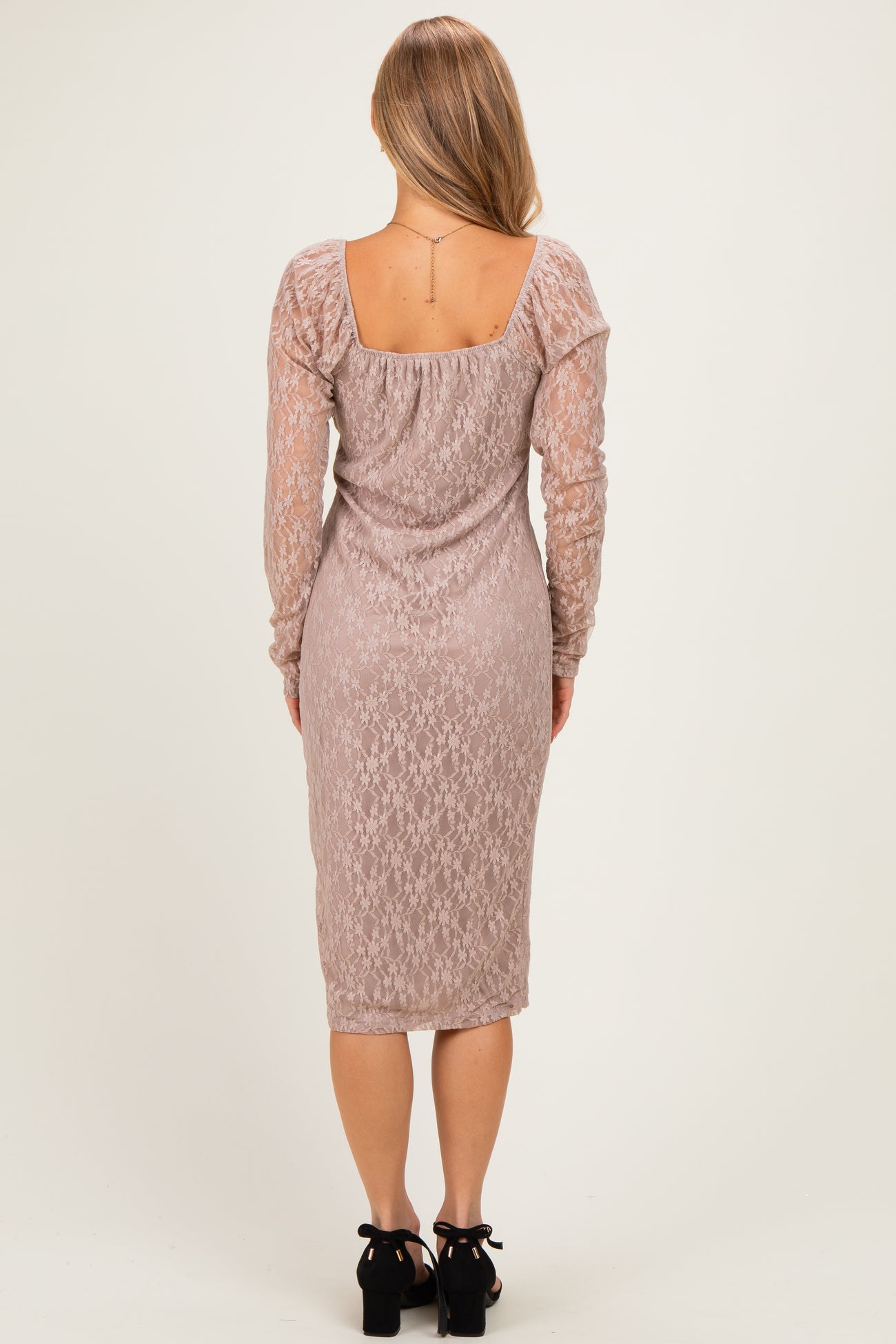 woman wearing a dusty rose long sleeve lace dress with a fitted silhouette and midi length, shown from the back