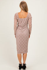 woman wearing a dusty rose long sleeve lace dress with a fitted silhouette and midi length, shown from the back