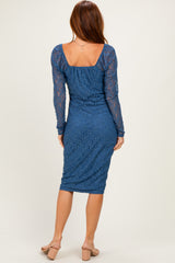 woman wearing a blue lace long sleeve dress with a fitted silhouette and square back neckline