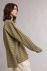 woman wearing a mustard yellow and navy striped long sleeve top with a relaxed fit