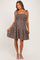 woman wearing a brown floral maternity dress with tie straps and a baby bump visible