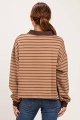 woman wearing a brown striped oversized sweatshirt with a ribbed collar and cuffs, seen from the back