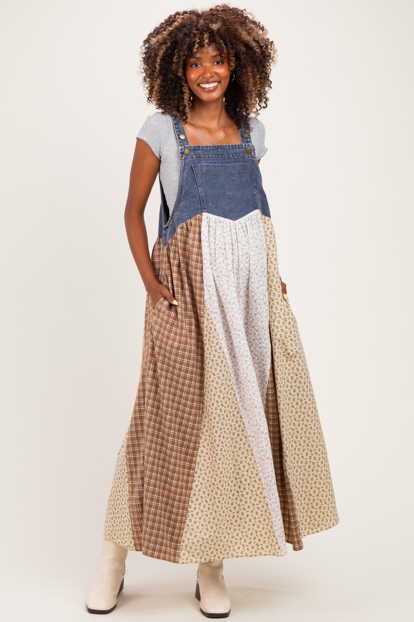 woman wearing a patchwork maternity maxi dress with denim and print patterns, featuring pockets and a relaxed fit