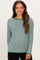 woman wearing a green and white striped maternity sweater with a relaxed fit and a rounded hem