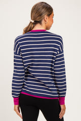 woman wearing a navy and cream striped maternity sweater with magenta cuffs and back view visible