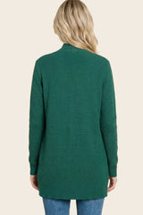 woman wearing a green long sleeve cardigan sweater, shown from the back with a relaxed fit and ribbed texture
