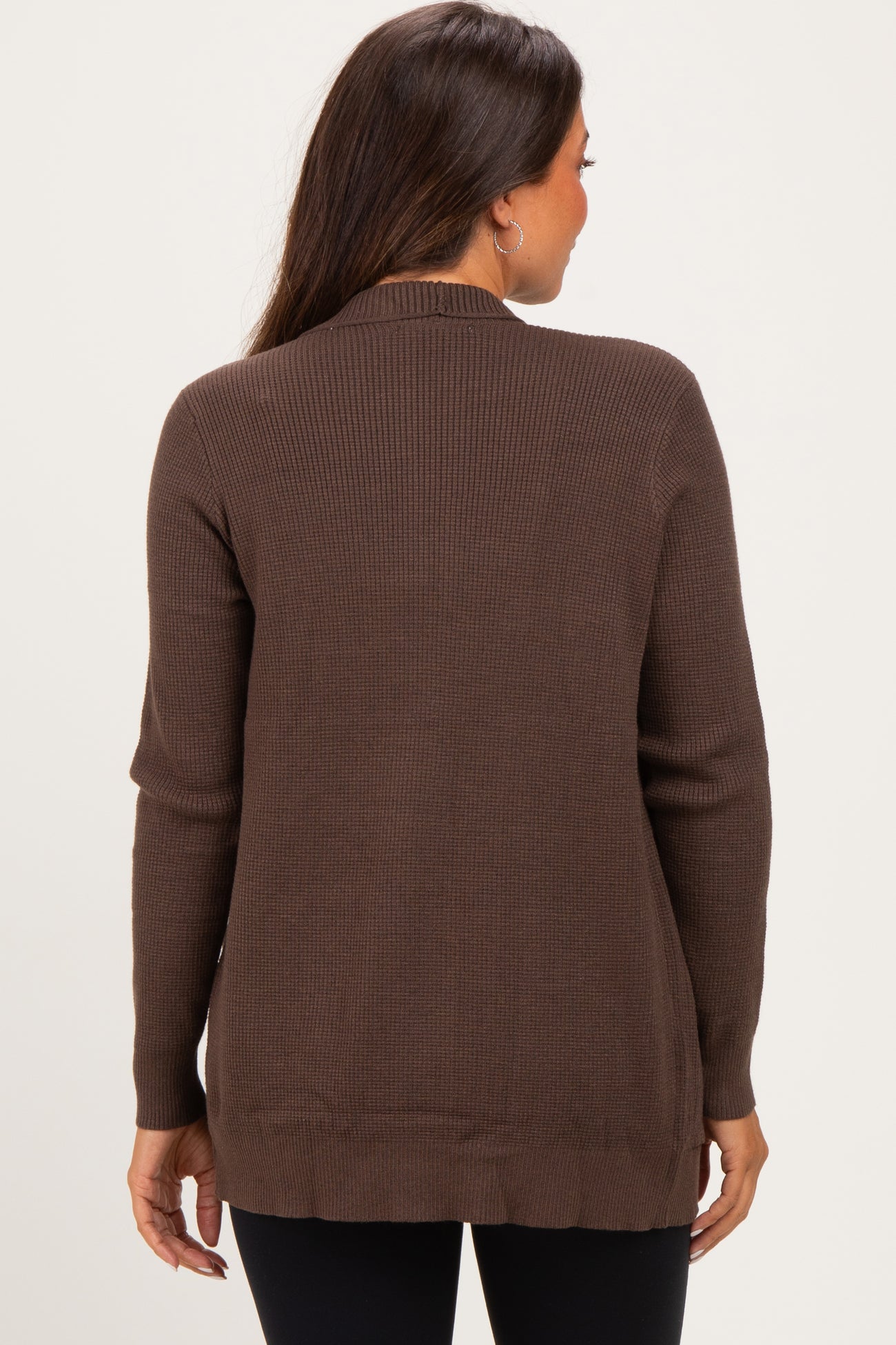 woman wearing a brown ribbed maternity cardigan, styled with a relaxed fit