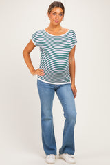 woman wearing a striped maternity top with a relaxed fit and blue flared jeans, showing a baby bump