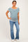woman wearing a striped maternity top with a relaxed fit and blue flared jeans, showing a baby bump