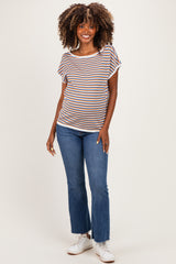 woman wearing a striped maternity top with short sleeves and blue jeans, showing her baby bump while smiling