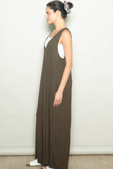 woman wearing a sleeveless brown maxi dress with a loose fit and side slits