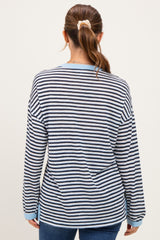 woman wearing a blue and white striped long sleeve maternity top, back view