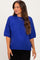 woman wearing a bright blue short sleeve maternity sweater with a relaxed fit and subtle ribbed detailing