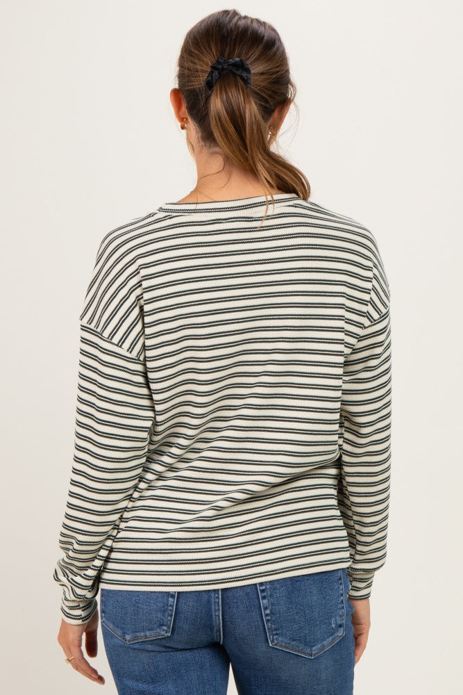 woman wearing a striped long sleeve maternity top, shown from the back with a relaxed fit and casual style