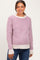 woman wearing a pink and white striped maternity sweater with a rounded neckline and long sleeves, smiling at the camera