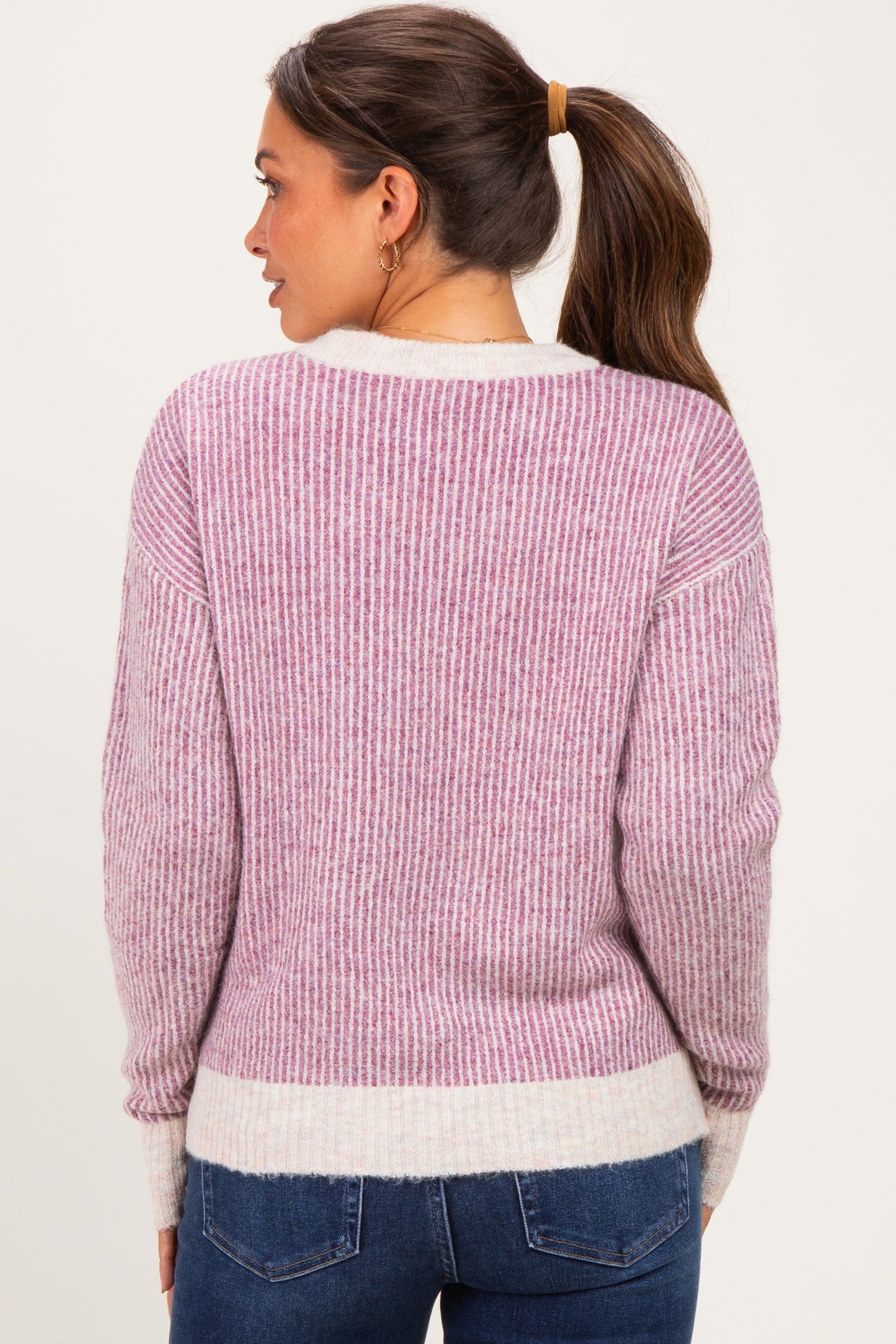 woman wearing a purple and white striped maternity sweater with a relaxed fit and long sleeves