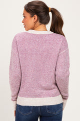 woman wearing a purple and white striped maternity sweater with a relaxed fit and long sleeves