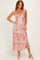 woman wearing a floral maxi dress with ruffled sleeves and a fitted bodice in shades of pink and peach