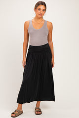 woman wearing a grey tank top and a flowing black maternity maxi skirt with a comfortable waistband
