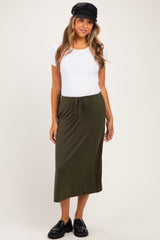 woman wearing a white short sleeve maternity top and an olive green maternity maxi skirt with drawstring detail