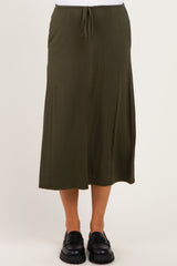 maternity wear olive green midi skirt with adjustable tie waist and relaxed fit, model standing with feet together