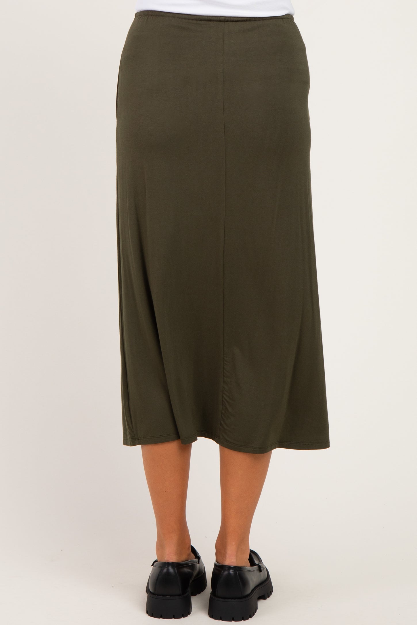 woman wearing a long olive green maternity skirt, shown from the back, featuring a relaxed fit and ankle length