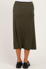 woman wearing a long olive green maternity skirt, shown from the back, featuring a relaxed fit and ankle length