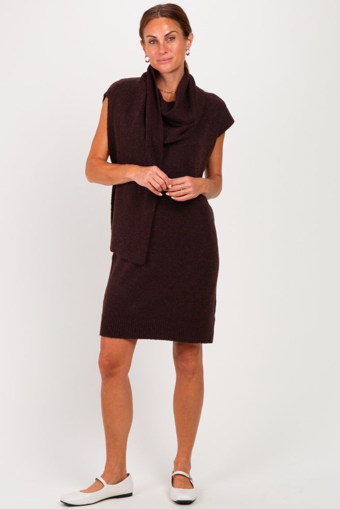 woman wearing a dark brown sleeveless sweater dress with a matching scarf and white shoes