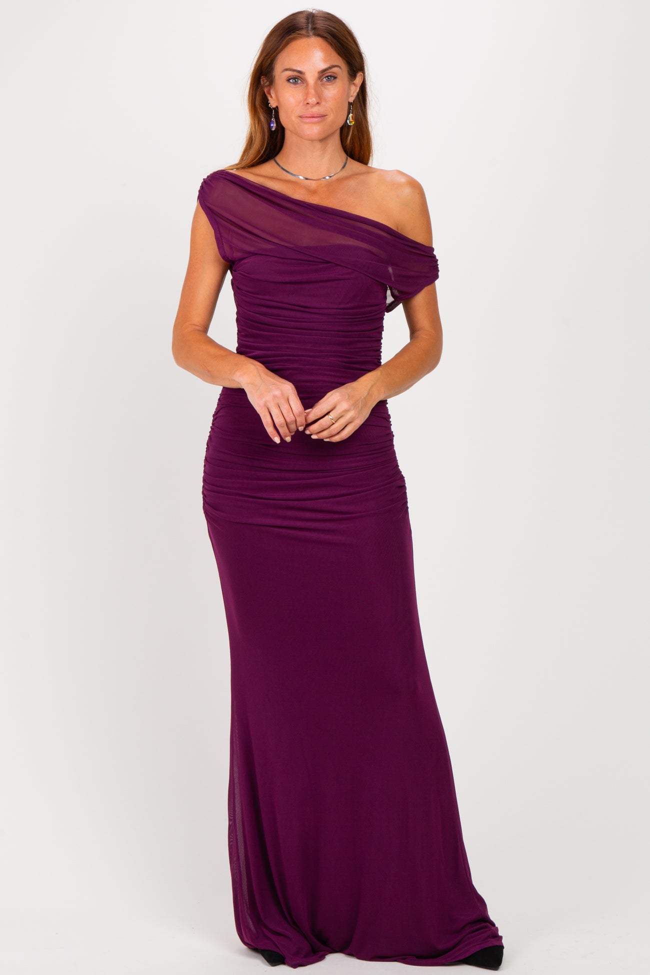 woman wearing a purple off-the-shoulder ruched evening gown with a flowing silhouette