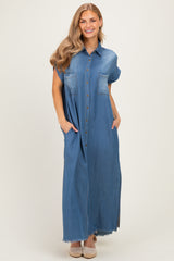 woman wearing a short sleeve blue denim maxi dress with button details and side pockets
