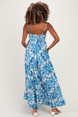 woman wearing a blue and white floral maternity maxi dress with adjustable straps and smocked back design