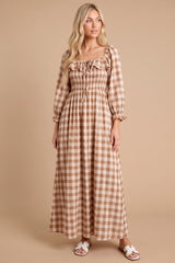 woman wearing a long brown gingham maxi dress with a square neck and puff sleeves