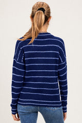 woman wearing a navy blue and light blue striped maternity sweater seen from the back
