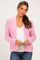 woman wearing a pink textured maternity cardigan over a white top and showing her baby bump