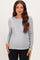 woman wearing a gray long sleeve maternity top and showing her baby bump