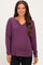 woman wearing a purple long sleeve maternity top with a v-neck and relaxed fit, showing her baby bump