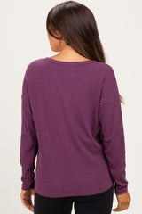 woman wearing a long sleeve purple maternity top with a relaxed fit and ribbed texture, showing the back view