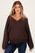woman wearing a dark brown v-neck maternity sweater with oversized sleeves and a relaxed fit